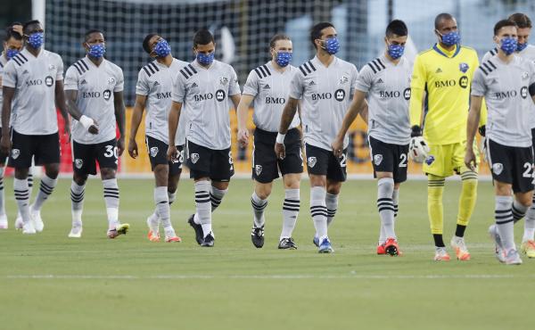 Members of the Montreal Impact, wearing masks, take the field for their match against Toronto FC as part of the MLS Is Back Tournament Thursday in Reunion, Fla. Members of the Montreal Impact, wearing masks, take the field for their match against Toronto FC as part of the MLS Is Back Tournament Thursday in Reunion, Fla.