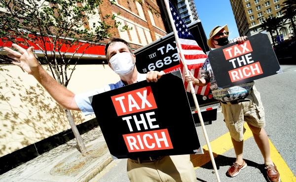 Two protesters from progressive group MoveON calling for higher taxes for the rich and corporations in Tampa, Fl., on May 17. Polls typically show support for increasing taxes for the wealthy. Two protesters from progressive group MoveON calling for higher taxes for the rich and corporations in Tampa, Fl., on May 17. Polls typically show support for increasing taxes for the wealthy.