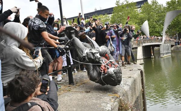 Protesters throw a statue of slave trader Edward Colston into Bristol Harbor on Sunday during a Black Lives Matter protest in England. Protesters throw a statue of slave trader Edward Colston into Bristol Harbor on Sunday during a Black Lives Matter protest in England.