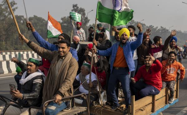 Protesting farmers riding tractors shout slogans as they march to the capital during India's Republic Day celebrations on Tuesday in New Delhi. Protesting farmers riding tractors shout slogans as they march to the capital during India's Republic Day celebrations on Tuesday in New Delhi.