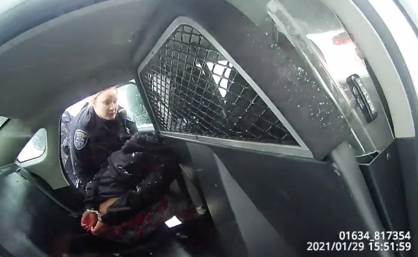 A frame from a Rochester Police Department body-camera video shows a girl in handcuffs in the back of a police cruiser. A frame from a Rochester Police Department body-camera video shows a girl in handcuffs in the back of a police cruiser.