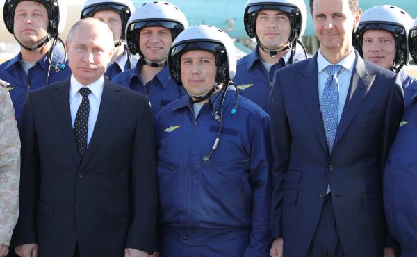Russian President Vladimir Putin, left, and Syrian President Bashar Assad, right, pose for a photo with Russian military pilots at the Hemeimeem air base in Syria last December. Russian President Vladimir Putin, left, and Syrian President Bashar Assad, right, pose for a photo with Russian military pilots at the Hemeimeem air base in Syria last December.