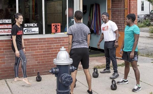 Justice Williams with gym goers and kettlebells at CORE in Brookline, Mass. Justice Williams with gym goers and kettlebells at CORE in Brookline, Mass.