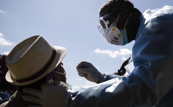 Dr. Pierre Chanoine administers a COVID-19 swab test on a person outside the Pinn Memorial Baptist Church in Philadelphia in April. The group Black Doctors COVID-19 Consortium offers testing at various locations to help address heath disparities in Africa Dr. Pierre Chanoine administers a COVID-19 swab test on a person outside the Pinn Memorial Baptist Church in Philadelphia in April. The group Black Doctors COVID-19 Consortium offers testing at various locations to help address heath disparities in Africa