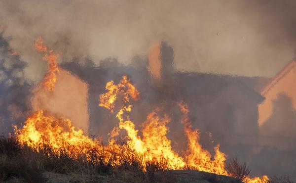 Flames approach houses during the Tick Fire on Oct. 24, 2019 in Canyon Country, California. Flames approach houses during the Tick Fire on Oct. 24, 2019 in Canyon Country, California.