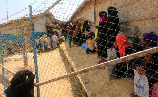 Rohingya refugees wait at a relief distribution point in the Kutupalong refugee camp in Bangladesh on March 24. Rohingya refugees wait at a relief distribution point in the Kutupalong refugee camp in Bangladesh on March 24.