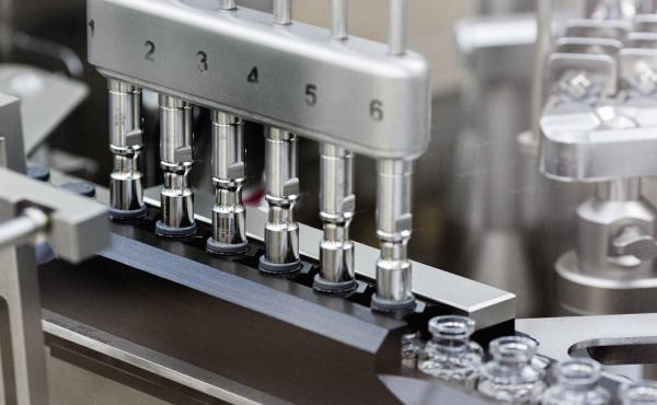 Stoppers are placed on filled vials of the experimental drug remdesivir at a Gilead Sciences factory. Stoppers are placed on filled vials of the experimental drug remdesivir at a Gilead Sciences factory.