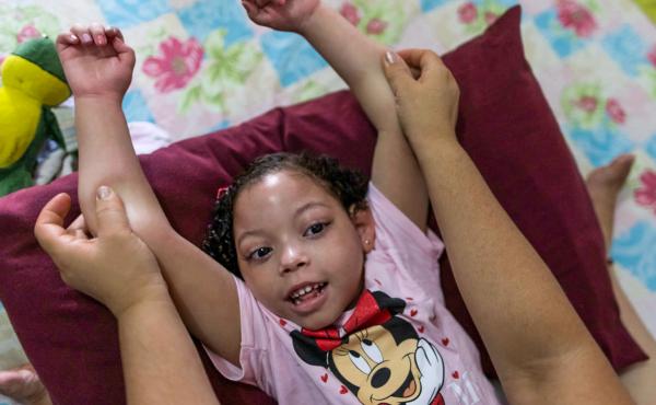 Rochelle dos Santos helps her daughter with physical therapy. Many children with congenital Zika disorder are physically disabled. Rochelle dos Santos helps her daughter with physical therapy. Many children with congenital Zika disorder are physically disabled.