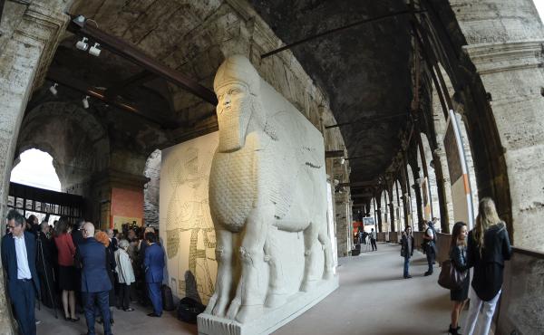 People walk past a replica of an ancient statue of a human-headed winged bull from Nimrud, Iraq, destroyed by the Islamic State. It's part of an exhibition called "Rising from Destruction" at Rome's Colosseum. People walk past a replica of an ancient statue of a human-headed winged bull from Nimrud, Iraq, destroyed by the Islamic State. It's part of an exhibition called "Rising from Destruction" at Rome's Colosseum.