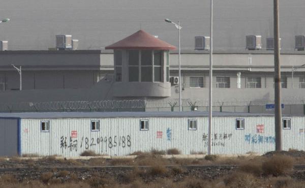 A guard tower and barbed wire fences are seen around the Kunshan Industrial Park in Artux in western China's Xinjiang region in December 2018. A guard tower and barbed wire fences are seen around the Kunshan Industrial Park in Artux in western China's Xinjiang region in December 2018.