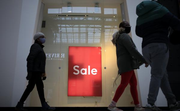 Shoppers walk past a "Sale" sign outside a store at the Easton Town Center Mall in Columbus, Ohio, on Jan. 7. Shoppers walk past a "Sale" sign outside a store at the Easton Town Center Mall in Columbus, Ohio, on Jan. 7.