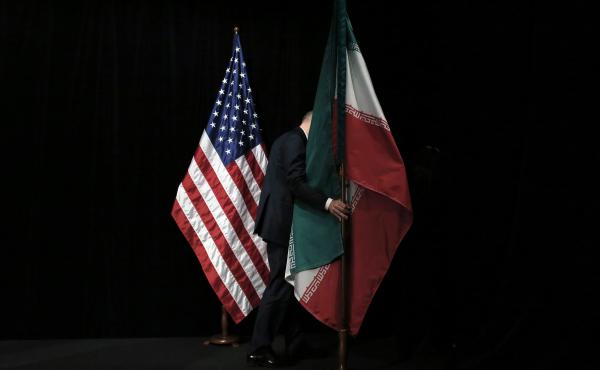 A staff person removes the Iranian flag from the stage after a group picture with representatives of the United States, Iran, China, Russia, Britain, Germany, France and the European Union during the Iran nuclear talks in July 2015 in Vienna. A staff person removes the Iranian flag from the stage after a group picture with representatives of the United States, Iran, China, Russia, Britain, Germany, France and the European Union during the Iran nuclear talks in July 2015 in Vienna.