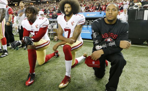 Then-San Francisco 49ers quarterback Colin Kaepernick (center) takes a knee during the playing of the national anthem before a game between the Atlanta Falcons and the 49ers on Dec. 18, 2016, in Atlanta. Then-San Francisco 49ers quarterback Colin Kaepernick (center) takes a knee during the playing of the national anthem before a game between the Atlanta Falcons and the 49ers on Dec. 18, 2016, in Atlanta.