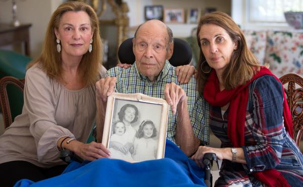 Laura Rees (left) and her sister Nancy Fee sit with their father, Joseph Fee, while holding a photo of his late wife, Elizabeth. Laura Rees (left) and her sister Nancy Fee sit with their father, Joseph Fee, while holding a photo of his late wife, Elizabeth.