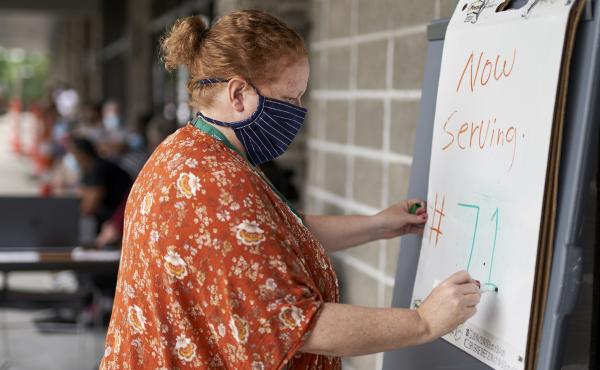 Vickie Gregorio with Heartland Workforce Solutions in Omaha, Neb., updates a whiteboard outside the workforce office as unemployed job seekers wait in line for help. A recent change in federal rules gives some people who have lost their health plan along Vickie Gregorio with Heartland Workforce Solutions in Omaha, Neb., updates a whiteboard outside the workforce office as unemployed job seekers wait in line for help. A recent change in federal rules gives some people who have lost their health plan along