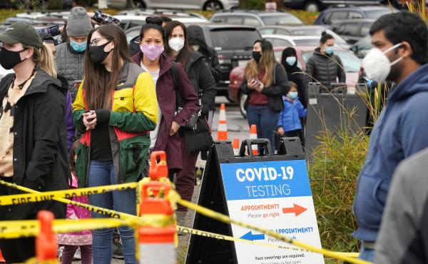 People line up to be tested for the coronavirus at a free testing site Wednesday, Nov. 18 in Seattle. People line up to be tested for the coronavirus at a free testing site Wednesday, Nov. 18 in Seattle.