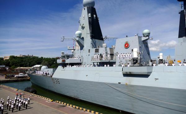 The British Royal Navy destroyer HMS Defender in the port of Odessa, Ukraine, on Tuesday. Russia said it fired warning shots at the warship Wednesday when it entered territorial waters off Crimea. The British Royal Navy destroyer HMS Defender in the port of Odessa, Ukraine, on Tuesday. Russia said it fired warning shots at the warship Wednesday when it entered territorial waters off Crimea.