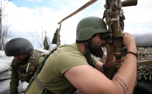 A Ukrainian serviceman looks through a periscope at his position on the fronline against Russia-backed separatists, not far from Donetsk, Ukraine, on Thursday. A Ukrainian serviceman looks through a periscope at his position on the fronline against Russia-backed separatists, not far from Donetsk, Ukraine, on Thursday.