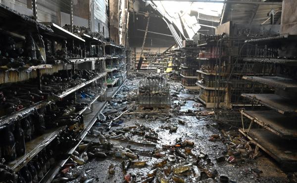 A photograph taken Tuesday shows charred goods in a grocery store of the destroyed Amstor mall in Kremenchuk, central Ukraine, one day after it was hit by a Russian missile strike. A photograph taken Tuesday shows charred goods in a grocery store of the destroyed Amstor mall in Kremenchuk, central Ukraine, one day after it was hit by a Russian missile strike.