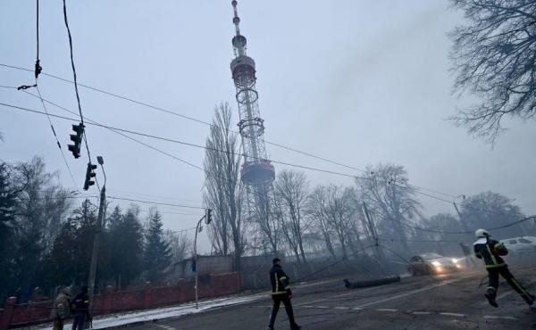 A fireman runs Tuesday after Russian airstrike hit Kyiv's main television tower in Kyiv in the heart of the Ukrainian capital. A fireman runs Tuesday after Russian airstrike hit Kyiv's main television tower in Kyiv in the heart of the Ukrainian capital.