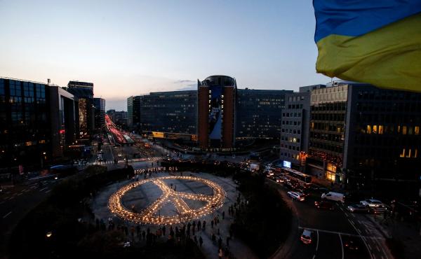 Demonstrators stand around a peace sign during a vigil for Ukraine near the European Union headquarters in Brussels on Tuesday. Activists are calling on EU leaders to impose a full ban on Russian fuel. Demonstrators stand around a peace sign during a vigil for Ukraine near the European Union headquarters in Brussels on Tuesday. Activists are calling on EU leaders to impose a full ban on Russian fuel.