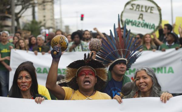 Indigenous people protest in defense of the Amazon in Rio de Janeiro on Sunday. Experts from the country's satellite monitoring agency say most of the fires are set by farmers or ranchers clearing existing farmland, but the same monitoring agency has repo Indigenous people protest in defense of the Amazon in Rio de Janeiro on Sunday. Experts from the country's satellite monitoring agency say most of the fires are set by farmers or ranchers clearing existing farmland, but the same monitoring agency has repo