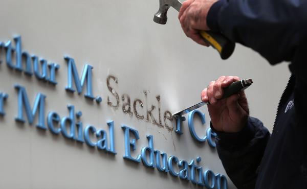 Tufts employee Gabe Ryan removes the Sackler family name from a building at Tufts University, the first major university to strip the Sackler name from buildings and programs. Tufts employee Gabe Ryan removes the Sackler family name from a building at Tufts University, the first major university to strip the Sackler name from buildings and programs.