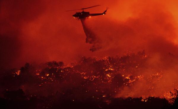 A helicopter drops water on the Cave Fire burning in the Los Padres National Forest above Santa Barbara, Calif., on Tuesday. A helicopter drops water on the Cave Fire burning in the Los Padres National Forest above Santa Barbara, Calif., on Tuesday.