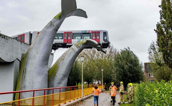 A massive sculpture of a whale's tail keeps a metro train aloft Monday after it shot through a stop block at De Akkers station in Spijkenisse, Netherlands. No injuries were reported. A massive sculpture of a whale's tail keeps a metro train aloft Monday after it shot through a stop block at De Akkers station in Spijkenisse, Netherlands. No injuries were reported.