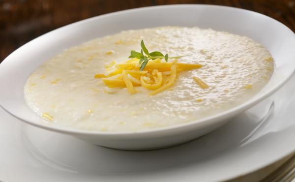 A bowl of creamy cheese grits. Food writer Erin Byers Murray hopes that exploring the story of grits will help spur more discussion about how food shapes our culture, as humble ingredients are elevated into expensive dishes even as we come to terms with l A bowl of creamy cheese grits. Food writer Erin Byers Murray hopes that exploring the story of grits will help spur more discussion about how food shapes our culture, as humble ingredients are elevated into expensive dishes even as we come to terms with l