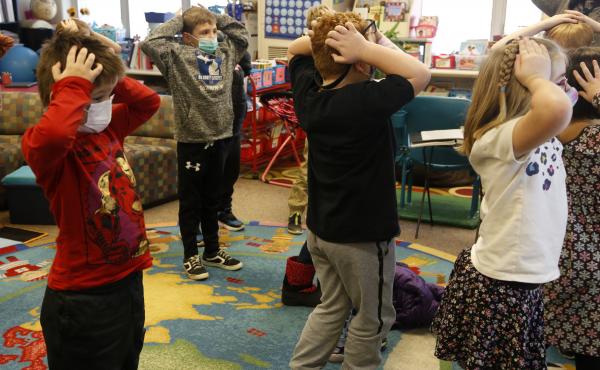 Second-graders hold their heads as they talk about "thoughts" and how they compare with "feelings" and resulting "actions," at Paw Paw Elementary School earlier this month, in Paw Paw, Mich. Second-graders hold their heads as they talk about "thoughts" and how they compare with "feelings" and resulting "actions," at Paw Paw Elementary School earlier this month, in Paw Paw, Mich.