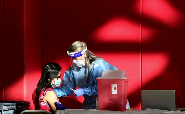 A registered nurse administers the COVID-19 vaccine at a high school gym in Corona, California. Scientists are trying to determine if vaccines (and boosters) will offer protection against the newly identified omicron variant. A registered nurse administers the COVID-19 vaccine at a high school gym in Corona, California. Scientists are trying to determine if vaccines (and boosters) will offer protection against the newly identified omicron variant.