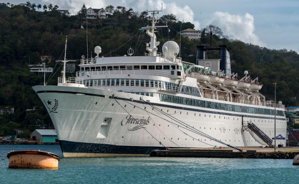 The Freewinds, a cruise ship owned by the Church of Scientology, is seen docked in quarantine in Castries, St. Lucia, on Thursday. The ship is now headed to the island of Curaçao, site of its home port. The Freewinds, a cruise ship owned by the Church of Scientology, is seen docked in quarantine in Castries, St. Lucia, on Thursday. The ship is now headed to the island of Curaçao, site of its home port.