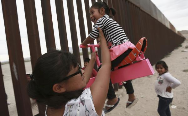 A set of pink seesaws allowed people to share some fun along the U.S.-Mexico border wall this week. Here, a woman helps her little girls ride the seesaw that was installed near Ciudad de Juarez, Mexico. A set of pink seesaws allowed people to share some fun along the U.S.-Mexico border wall this week. Here, a woman helps her little girls ride the seesaw that was installed near Ciudad de Juarez, Mexico.