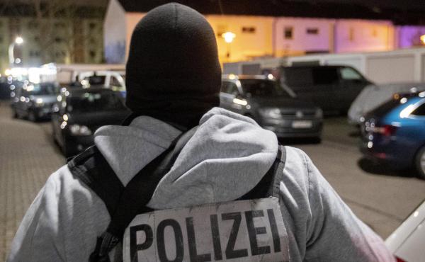 A police officer guards the road in front of a house where police found the bodies of the suspected gunman and his mother, in Hanau, Germany, on Thursday. A police officer guards the road in front of a house where police found the bodies of the suspected gunman and his mother, in Hanau, Germany, on Thursday.