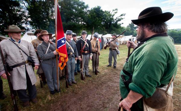 Waverly Adcock, a sergeant and founder of the West Augusta Guard, prepares his company for inspection and battle at a Civil War re-enactment in Virginia. Sara Smith, whose great-great-grandfather was wounded at the Battle of Gettysburg, holds the Confeder Waverly Adcock, a sergeant and founder of the West Augusta Guard, prepares his company for inspection and battle at a Civil War re-enactment in Virginia. Sara Smith, whose great-great-grandfather was wounded at the Battle of Gettysburg, holds the Confeder