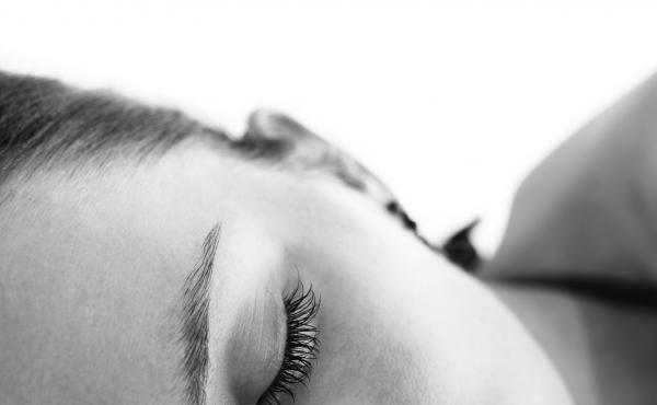 Close-up of a part of the face of young woman taking nap. Close-up of a part of the face of young woman taking nap.