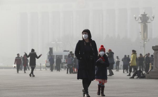 A foreign tourist and a child wearing protection masks walk through Tiananmen Square in Beijing as the city was blanketed by heavy smog last week. A foreign tourist and a child wearing protection masks walk through Tiananmen Square in Beijing as the city was blanketed by heavy smog last week.