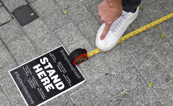 Workers use a tape measure mark spaces six feet apart for people to wait in line safely as they convert the outdoor plaza in front of Zaytinya, one of Chef José Andres' restaurants in Washington, D.C. Efforts to contain the coronavirus are affecting bloo Workers use a tape measure mark spaces six feet apart for people to wait in line safely as they convert the outdoor plaza in front of Zaytinya, one of Chef José Andres' restaurants in Washington, D.C. Efforts to contain the coronavirus are affecting bloo