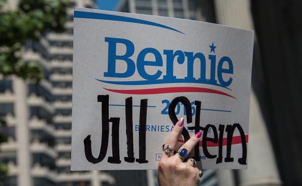 A supporter of Green Party candidate Jill Stein holds a doctored Bernie Sanders sign at a rally at City Hall in Philadelphia during the Democratic National Convention last month. A supporter of Green Party candidate Jill Stein holds a doctored Bernie Sanders sign at a rally at City Hall in Philadelphia during the Democratic National Convention last month.