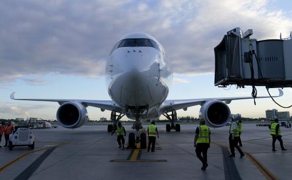A Lufthansa flight arrives at Miami International Airport last month. The German airline, along with United and Delta, reported canceling dozens of Christmas Eve departures as illnesses tied to the omicron variant of COVID-19 take a toll on flight crew. A Lufthansa flight arrives at Miami International Airport last month. The German airline, along with United and Delta, reported canceling dozens of Christmas Eve departures as illnesses tied to the omicron variant of COVID-19 take a toll on flight crew.
