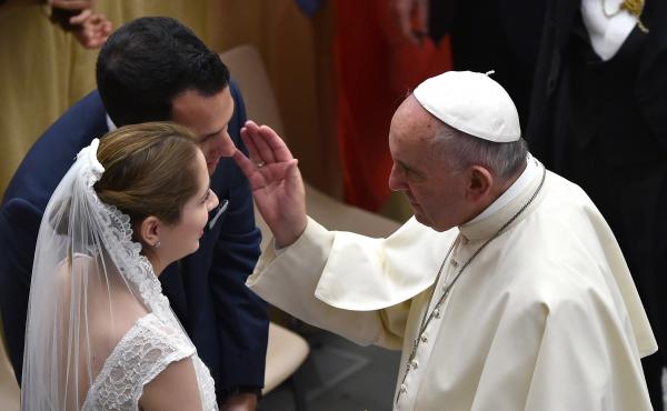 Pope Francis blesses a newlywed couple during his weekly audience in the Paul VI hall in Vatican City on Aug. 12, 2015. Pope Francis blesses a newlywed couple during his weekly audience in the Paul VI hall in Vatican City on Aug. 12, 2015.
