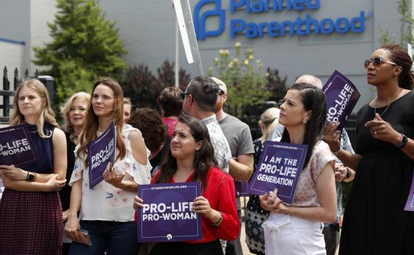 Anti-abortion-rights advocates gather outside a St. Louis Planned Parenthood clinic in June. Title X recipients have been given more time to comply with new regulations. Anti-abortion-rights advocates gather outside a St. Louis Planned Parenthood clinic in June. Title X recipients have been given more time to comply with new regulations.