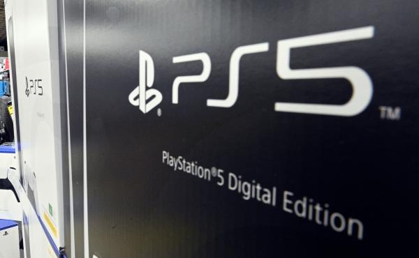 A customer waits in a queue inside an electronics store in Sydney on Nov. 12, 2020, on the day of the official launch of Sony's next-generation PlayStation 5 gaming console. A customer waits in a queue inside an electronics store in Sydney on Nov. 12, 2020, on the day of the official launch of Sony's next-generation PlayStation 5 gaming console.