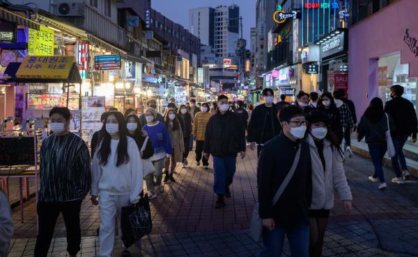People wearing face masks walk on a street Sunday in the Hongdae district of Seoul, South Korea. People wearing face masks walk on a street Sunday in the Hongdae district of Seoul, South Korea.