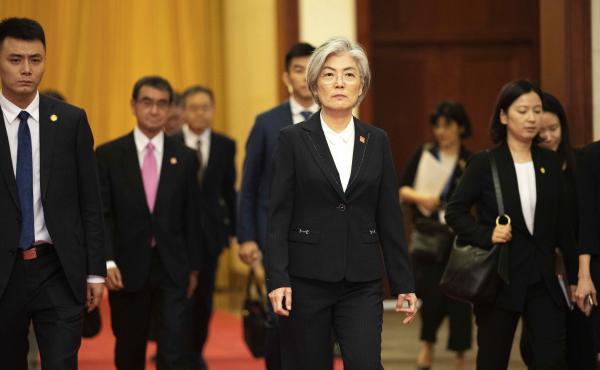 South Korea has announced it will withdraw from a 2016 military intelligence-sharing pact with Japan. Here, South Korean Foreign Minister Kang Kyung-wha, center, and Japanese Foreign Minister Taro Kono, trailing at left, walk in Beijing's Great Hall of th South Korea has announced it will withdraw from a 2016 military intelligence-sharing pact with Japan. Here, South Korean Foreign Minister Kang Kyung-wha, center, and Japanese Foreign Minister Taro Kono, trailing at left, walk in Beijing's Great Hall of th