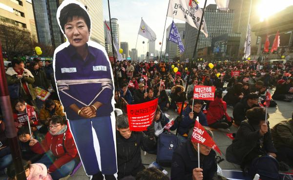 Protesters carry a portrait of South Korea's President Park Geun-Hye during a rally against Park in central Seoul on Saturday. Hundreds of thousands of protestors marched in Seoul for the sixth straight week on December 3, to demand the ouster and arrest Protesters carry a portrait of South Korea's President Park Geun-Hye during a rally against Park in central Seoul on Saturday. Hundreds of thousands of protestors marched in Seoul for the sixth straight week on December 3, to demand the ouster and arrest