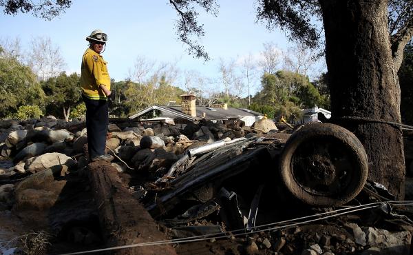 A firefighter searches for people trapped in mudslide debris on Jan. 10 in Montecito, Calif. A firefighter searches for people trapped in mudslide debris on Jan. 10 in Montecito, Calif.