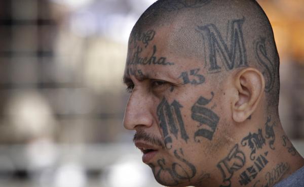 An MS-13 gang member at a prison in Salvador. As the gang spread from Central America to the U.S., authorities say its symbols became more subtle. An MS-13 gang member at a prison in Salvador. As the gang spread from Central America to the U.S., authorities say its symbols became more subtle.
