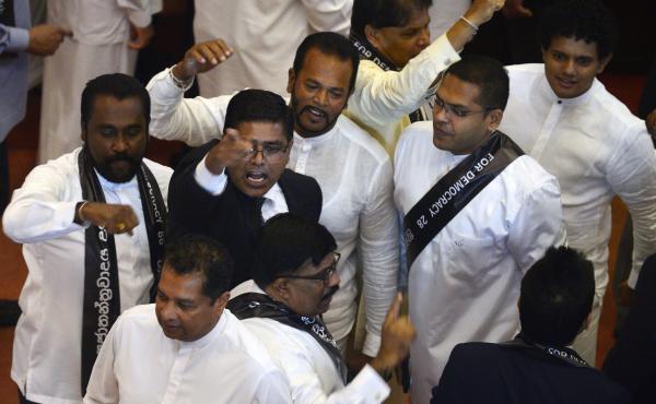Members of the Sri Lankan parliament shout slogans in support of former Prime Minister Ranil Wickremesinghe during a parliament session in Colombo on Wednesday that ousted his successor, Mahinda Rajapaksa. Members of the Sri Lankan parliament shout slogans in support of former Prime Minister Ranil Wickremesinghe during a parliament session in Colombo on Wednesday that ousted his successor, Mahinda Rajapaksa.